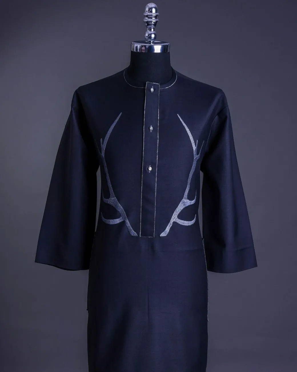 A charcoal black front flap, deer horn embroidery, clear view Swarovski buttons, 3/4 sleeve details, African senator Kaftan native.