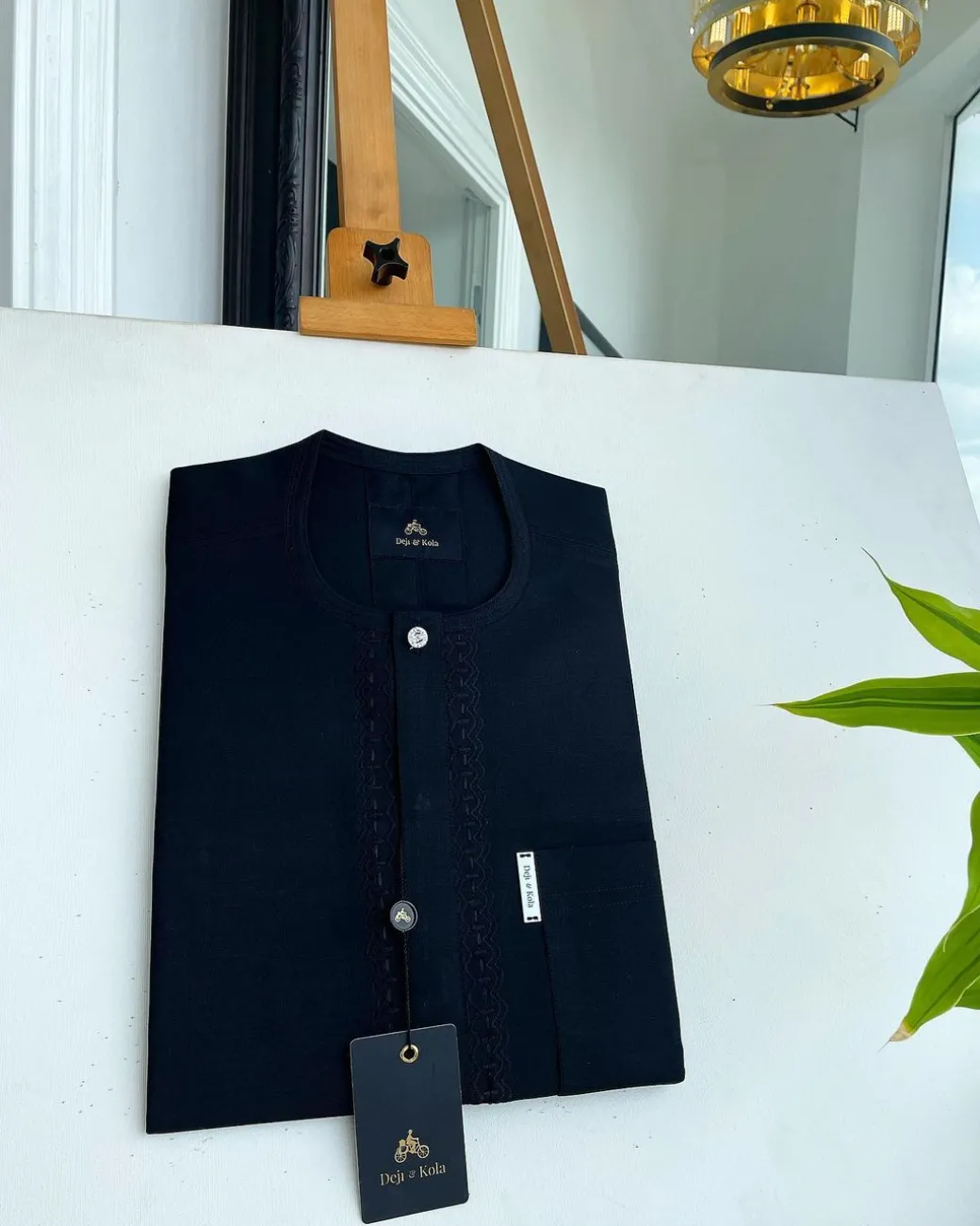 A Charcoal black front flap, interconnected embroidery, and a Swarovski button detail African traditional senator Kaftan native.