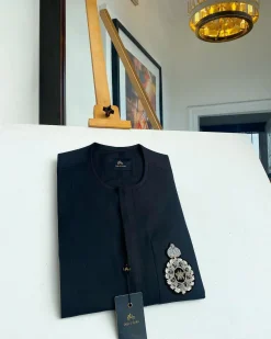 A charcoal black front flap and hand embroidery patch detail traditional African kaftan