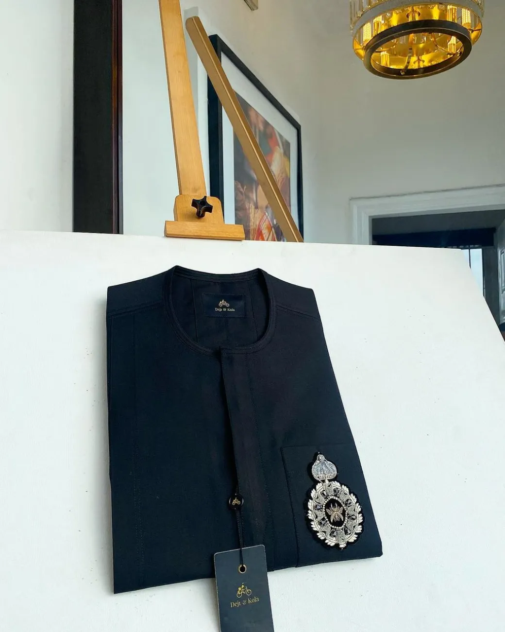 A charcoal black front flap and hand embroidery patch detail traditional African kaftan