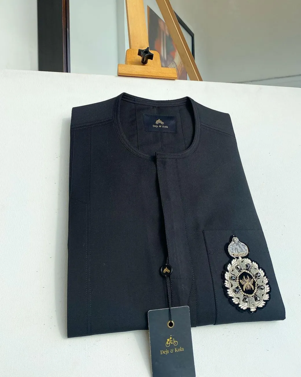 A charcoal black front flap and hand embroidery patch detail traditional African kaftan