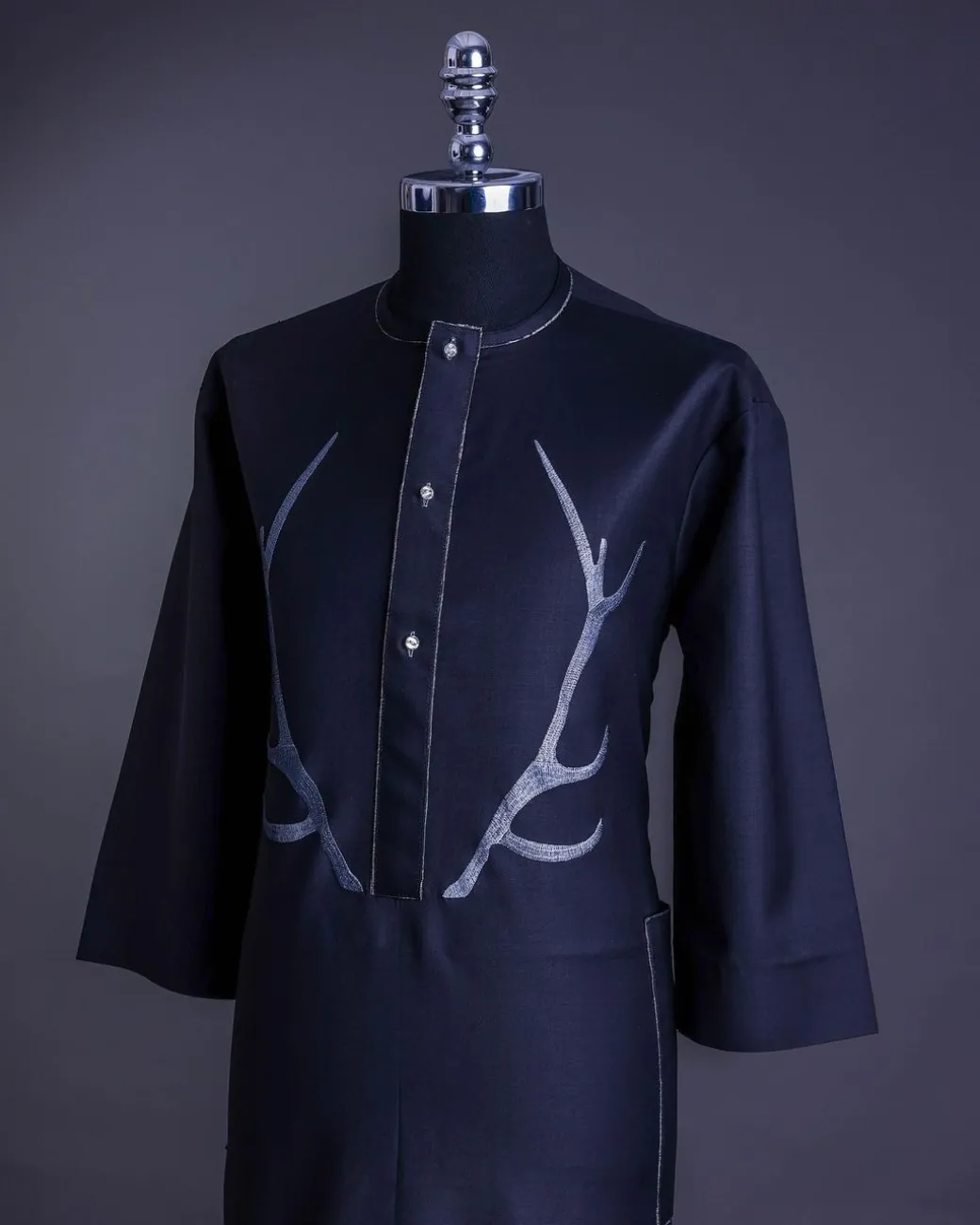 A charcoal black front flap, deer horn embroidery, clear view Swarovski buttons, 3/4 sleeve details, African senator Kaftan native.
