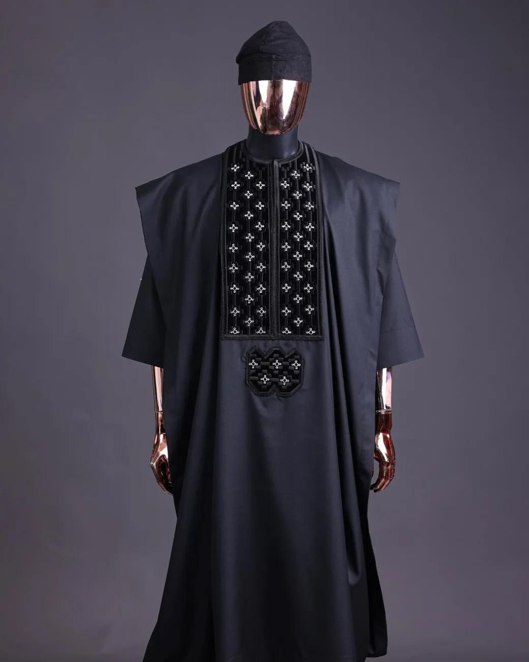 A charcoal black, grommet eyelet on dropping octa with silver Swarovski embroidery details agbada