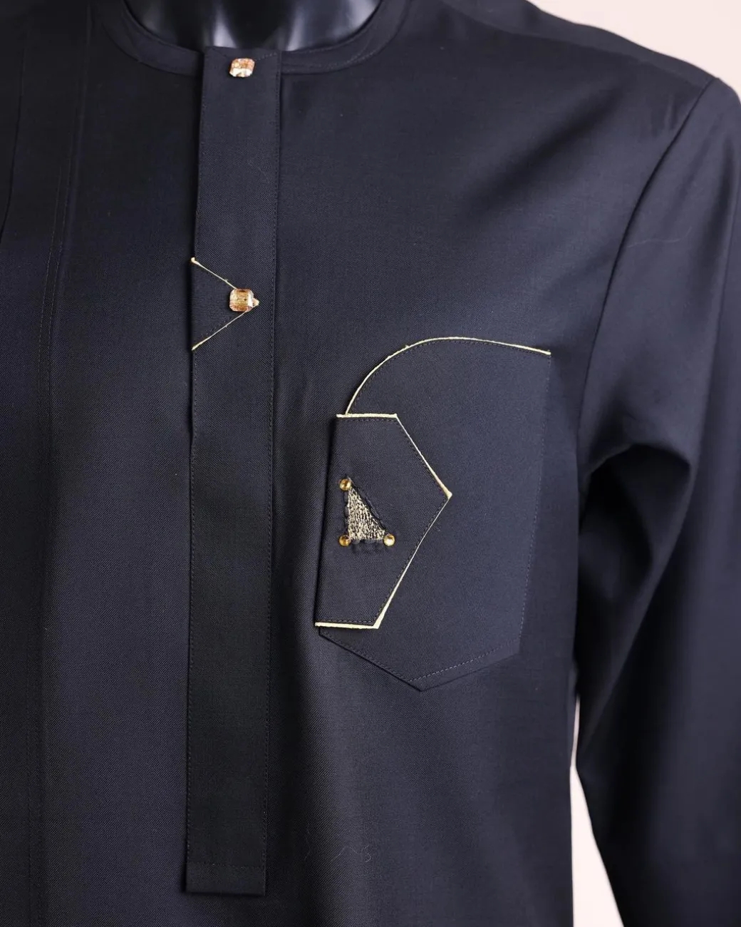 A charcoal black, inverted and closed flap shaped pocket details, 3/4 sleeve African senator kaftan native.