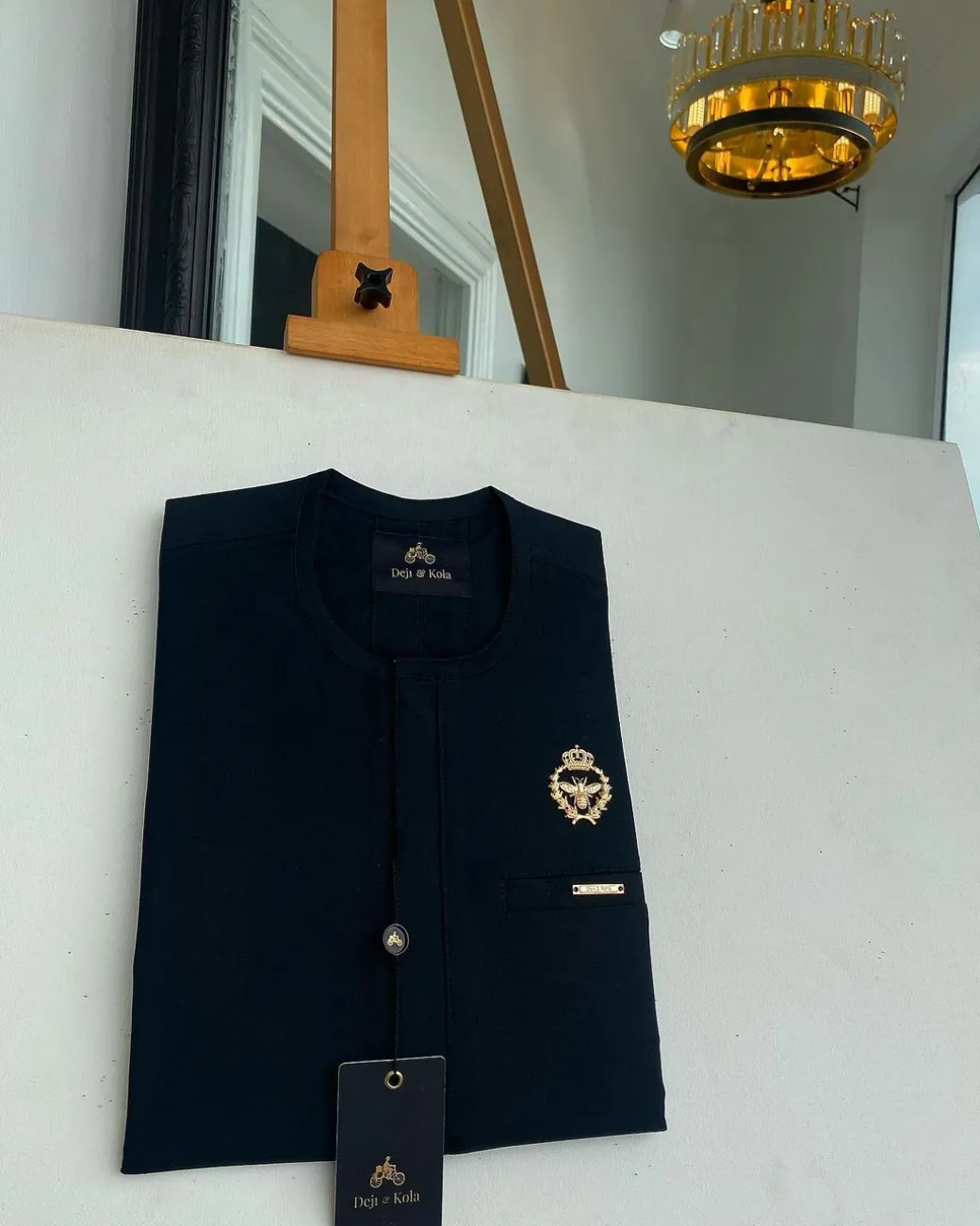 A charcoal black, Tiny Flap with Gold Queen bee crown details African traditional senator kaftan native.