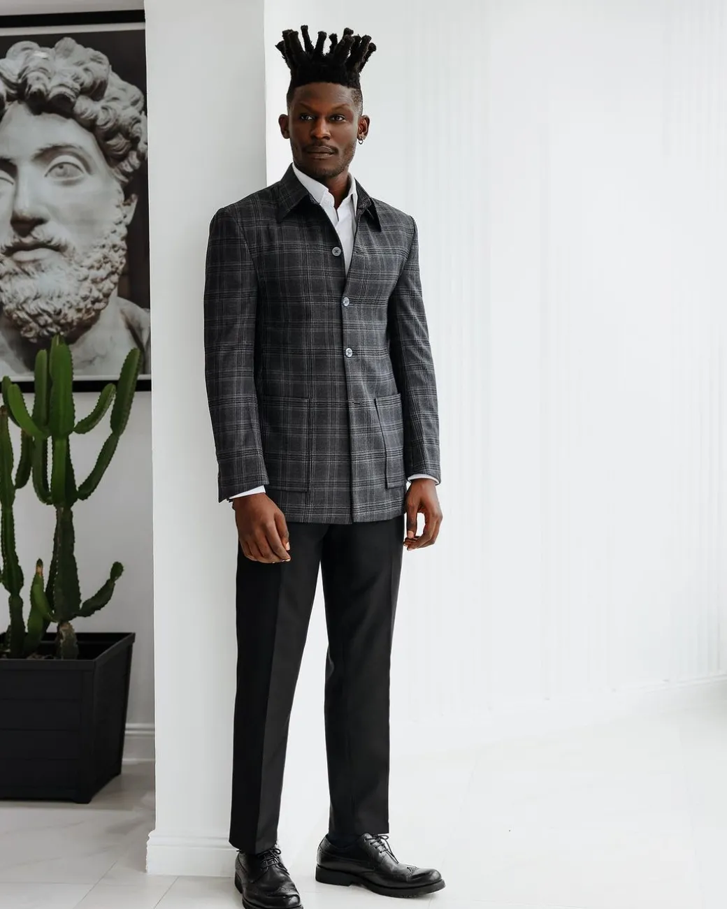 A Charcoal grey, windowpane check, nobility fabric cover coat with patch pocket detailing