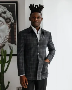 A Charcoal grey, windowpane check, nobility fabric cover coat with patch pocket detailing