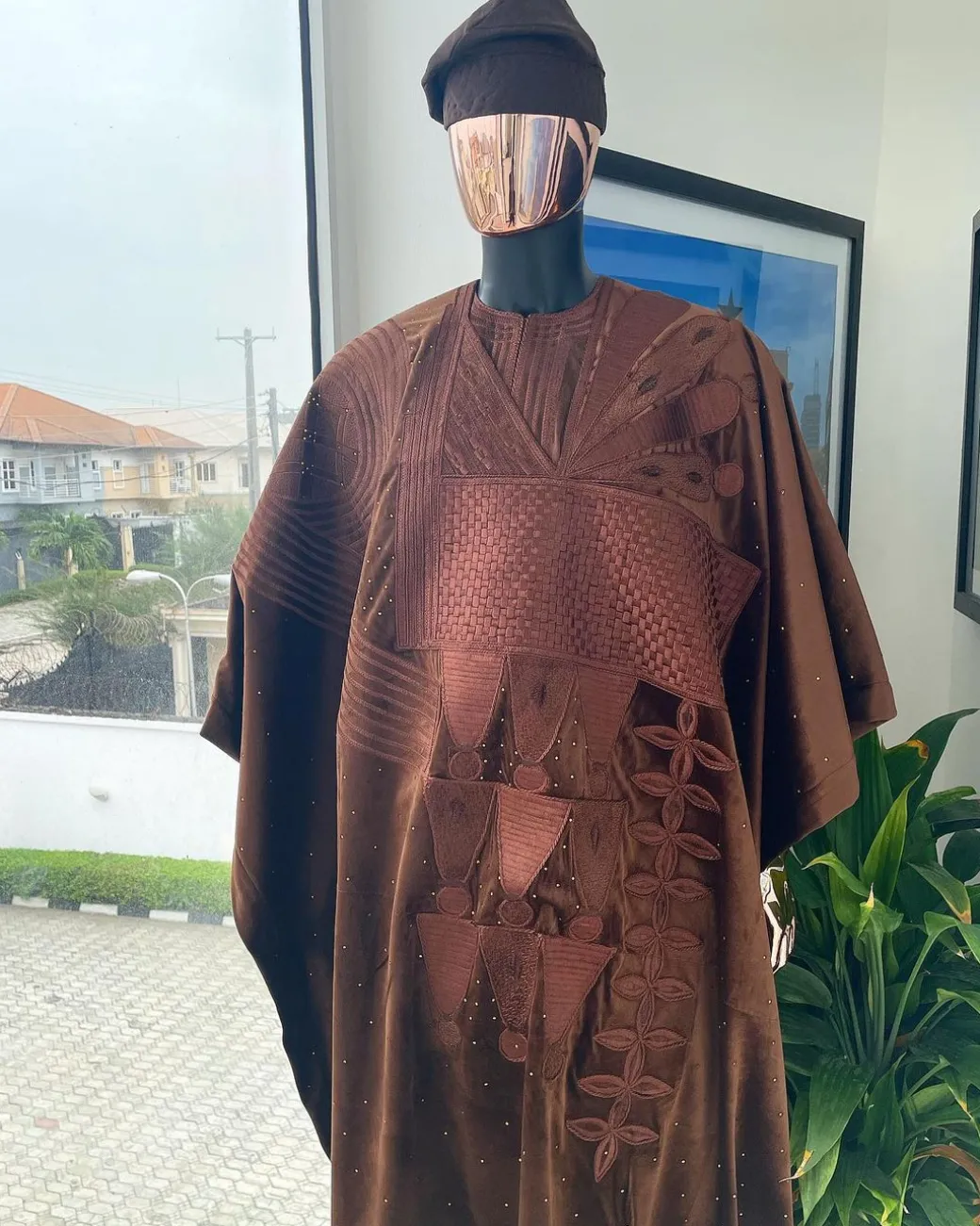 A chocolate brown royal embroidery design agbada, dashiki, hand-knitted matching hat, and Sokoto