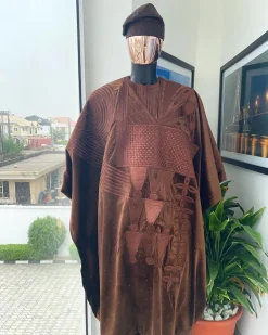 A chocolate brown royal embroidery design agbada, dashiki, hand-knitted matching hat, and Sokoto