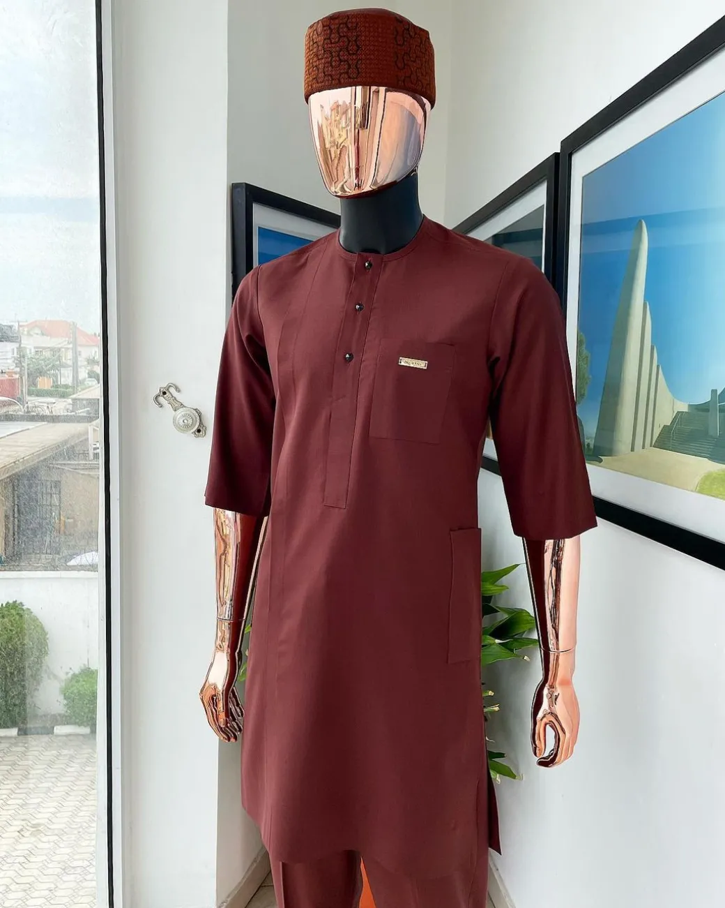 A cinnamon brown 3/4 sleeve kaftan, Swarovski buttons, flap, and spiral binding embroidery hat detailing traditional senator kaftan native