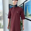 A cinnamon brown 3/4 sleeve kaftan, Swarovski buttons flap, and layered eggplant embroidery hat detail traditional senator kaftan native