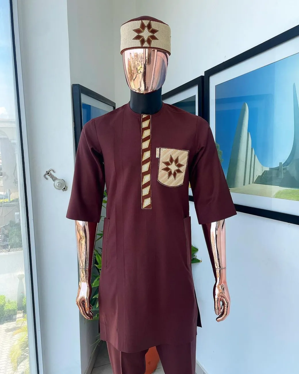 A cinnamon brown, sunrise in the east embroidery detailing hat & patch pocket traditional senator kaftan native.