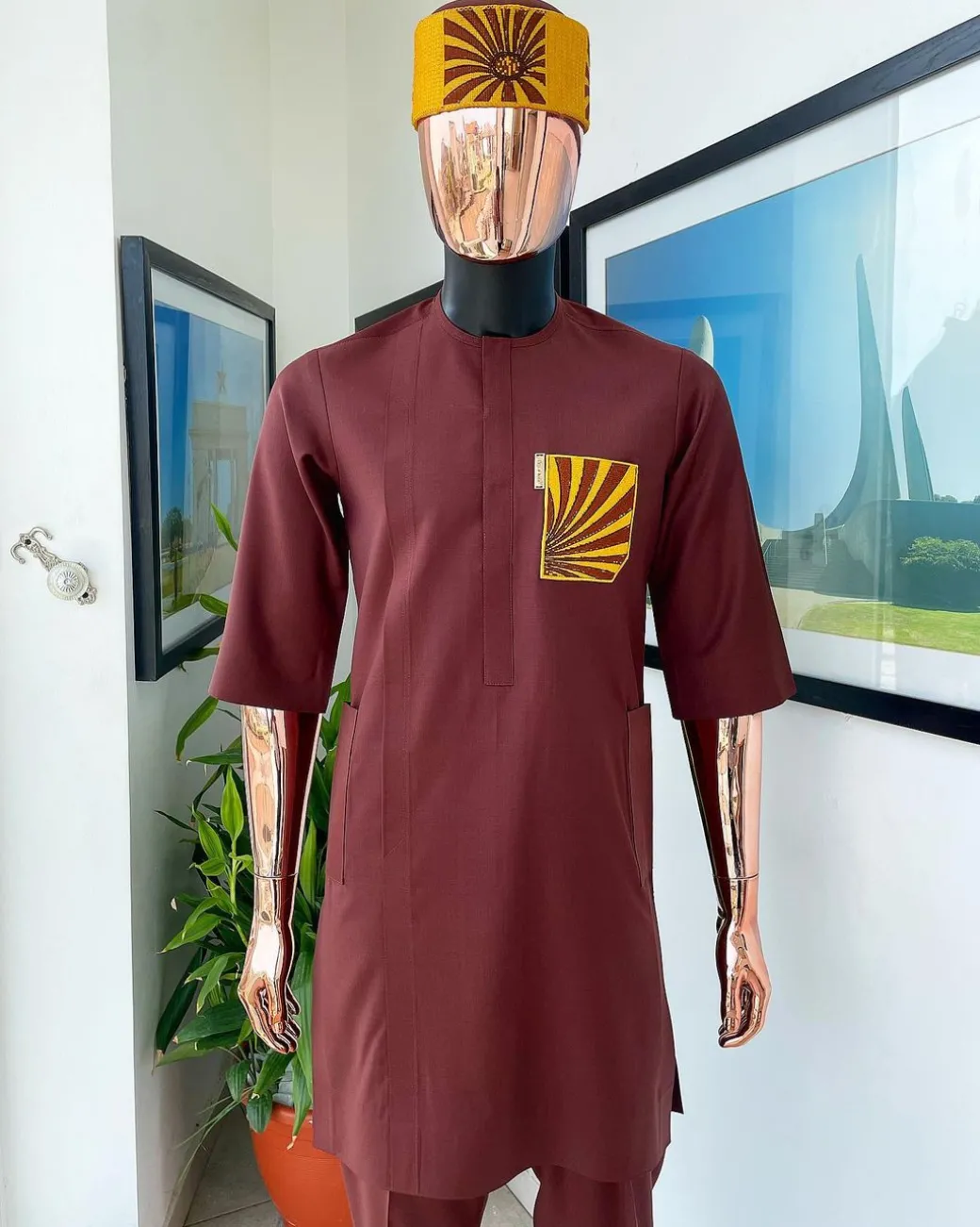 A Cinnamon brown, sunset in the east embroidery detailing hat and patch pocket traditional senator kaftan native.