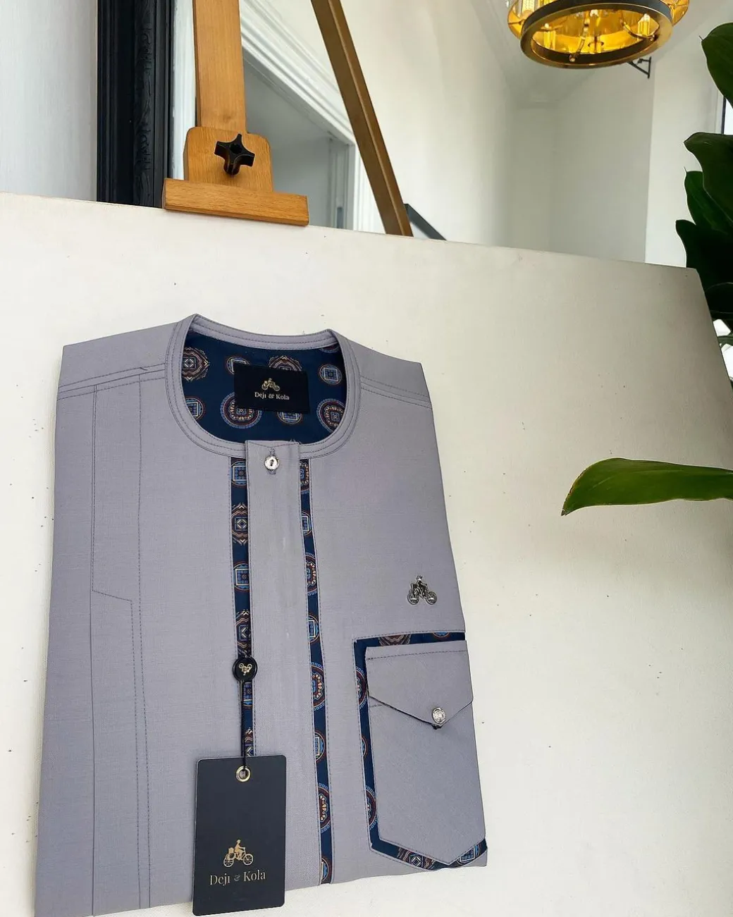 A Cloud Grey, clear view transparent Swarovski buttons, front flap, edge paisley cut pocket details African traditional senator kaftan native.