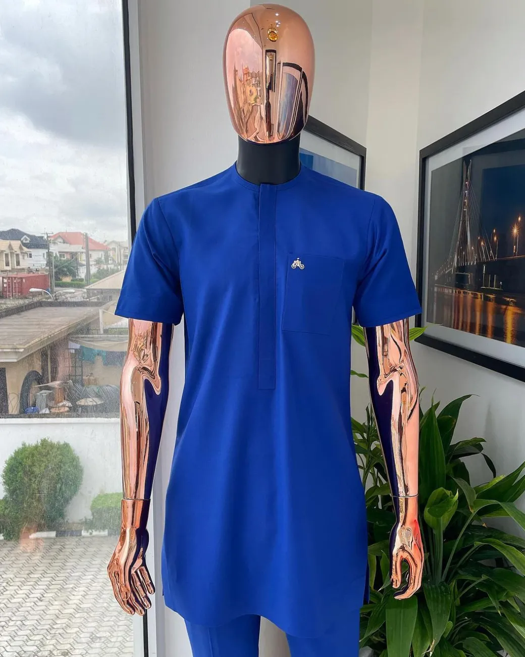 A cobalt blue front flap with a patch pocket details African traditional senator kaftan native