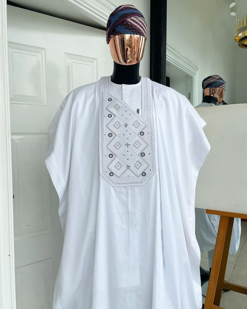 A Cocaine white, Square dropping-layered embroidery design details agbada