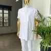 A Cocaine white voil short sleeve men’s tailored senator kaftan with a light weave pink kanuri hat
