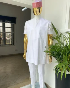 A Cocaine white voil short sleeve men’s tailored senator kaftan with a light weave pink kanuri hat