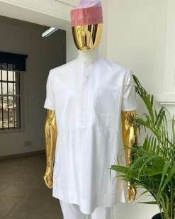 A Cocaine white voil short sleeve men’s tailored senator kaftan with a light weave pink kanuri hat