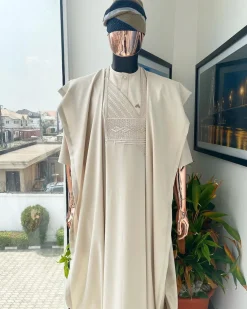 A coconut ivory, jakan design agbada, 3/4 sleeve buba laced with Swarovski stone button details and sokoto