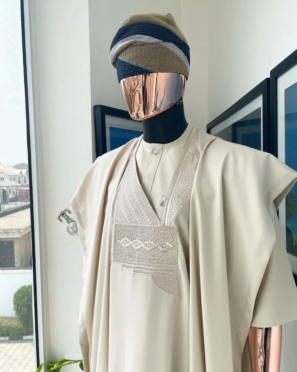 A coconut ivory, jakan design agbada, 3/4 sleeve buba laced with Swarovski stone button details and sokoto