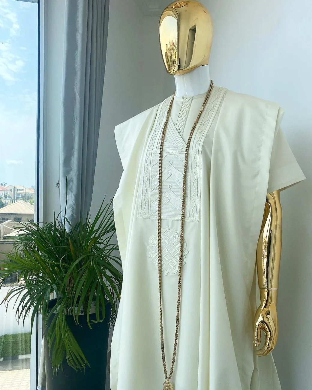 A cream African Agbada with interwoven embroidery design, short sleeve senator kaftan and sokoto