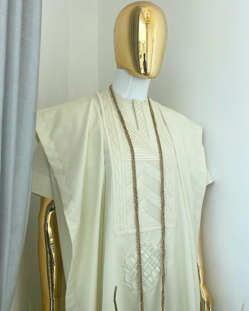 A cream African Agbada with interwoven embroidery design, short sleeve senator kaftan and sokoto