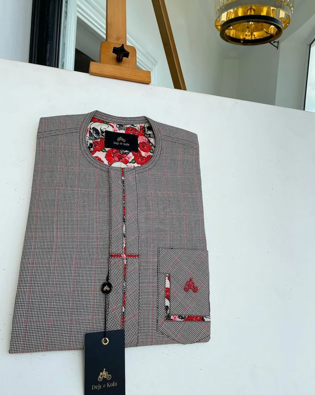 A Dark brown windowpane check, cross-details front flap, and sliding patch pocket African traditional kaftan native