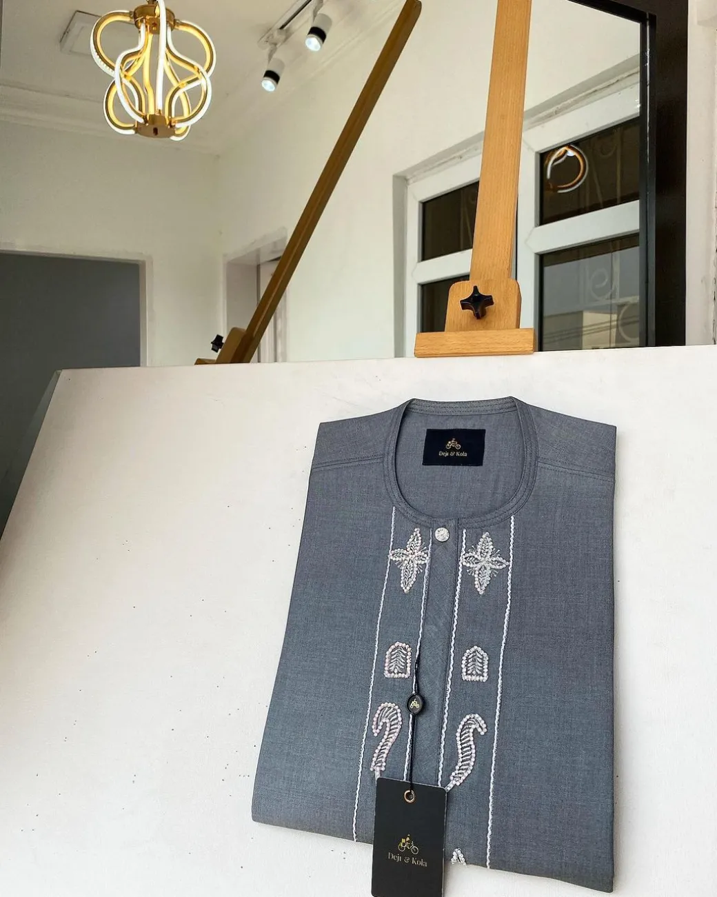 A Dark grey Irish petal embroidery detail and a mid-section flap button Swarovski African kaftan