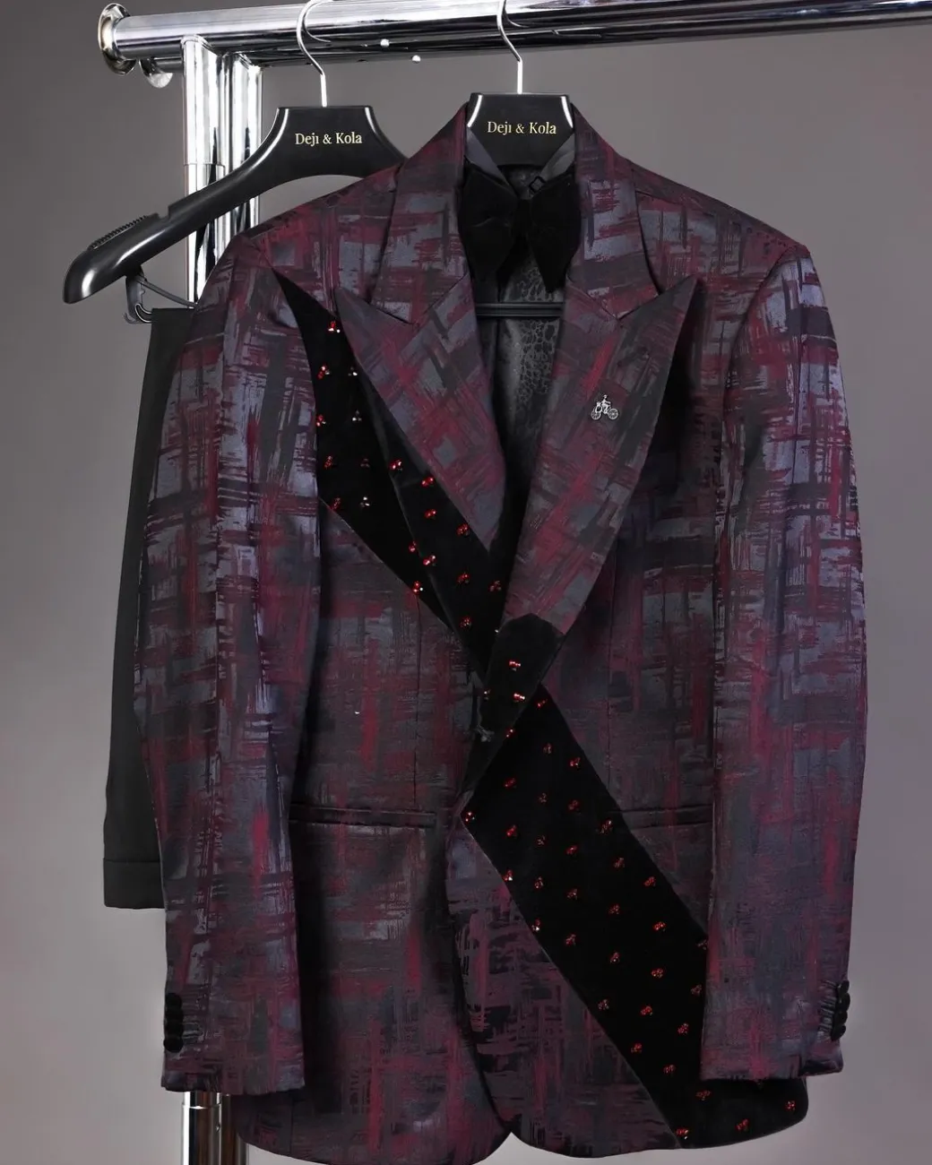 A diagonal cut layered black velvet Swarovski detailing burgundy and black patterned suit