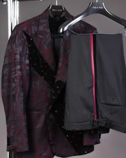 A diagonal cut layered black velvet Swarovski detailing burgundy and black patterned suit