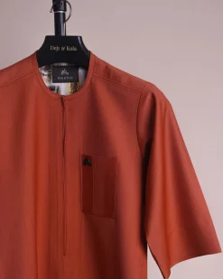 A fire orange and black pencil stripe, zipline, 3/4 sleeve African senator kaftan native.