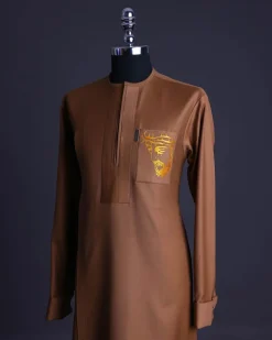 A Gingerbread brown, wide double lane flap, patch pocket with “Golgotha” embroidery detailing African senator kaftan native.