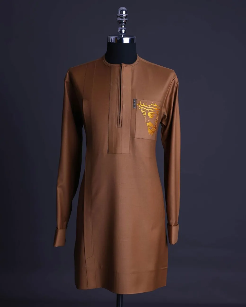 A Gingerbread brown, wide double lane flap, patch pocket with “Golgotha” embroidery detailing African senator kaftan native.