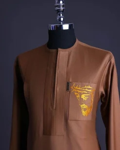 A Gingerbread brown, wide double lane flap, patch pocket with “Golgotha” embroidery detailing African senator kaftan native.