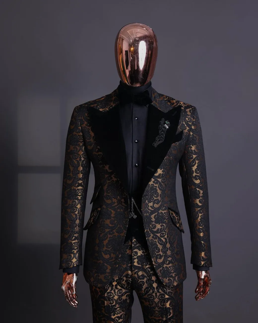 A Gold and black mandarin metallic floral jacquard, peak lapel tuxedo suit.