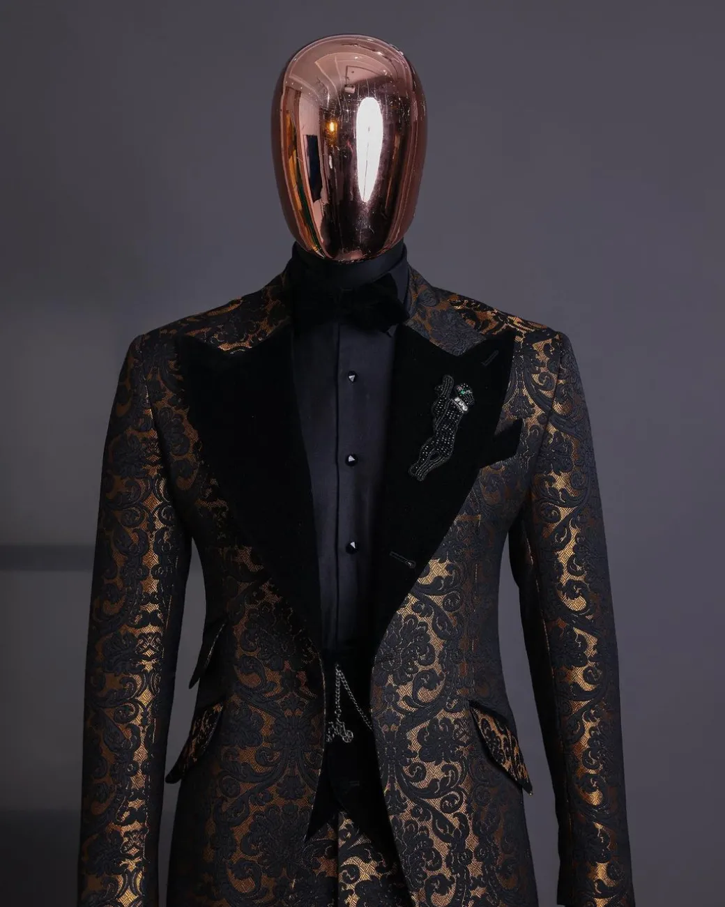 A Gold and black mandarin metallic floral jacquard, peak lapel tuxedo suit.