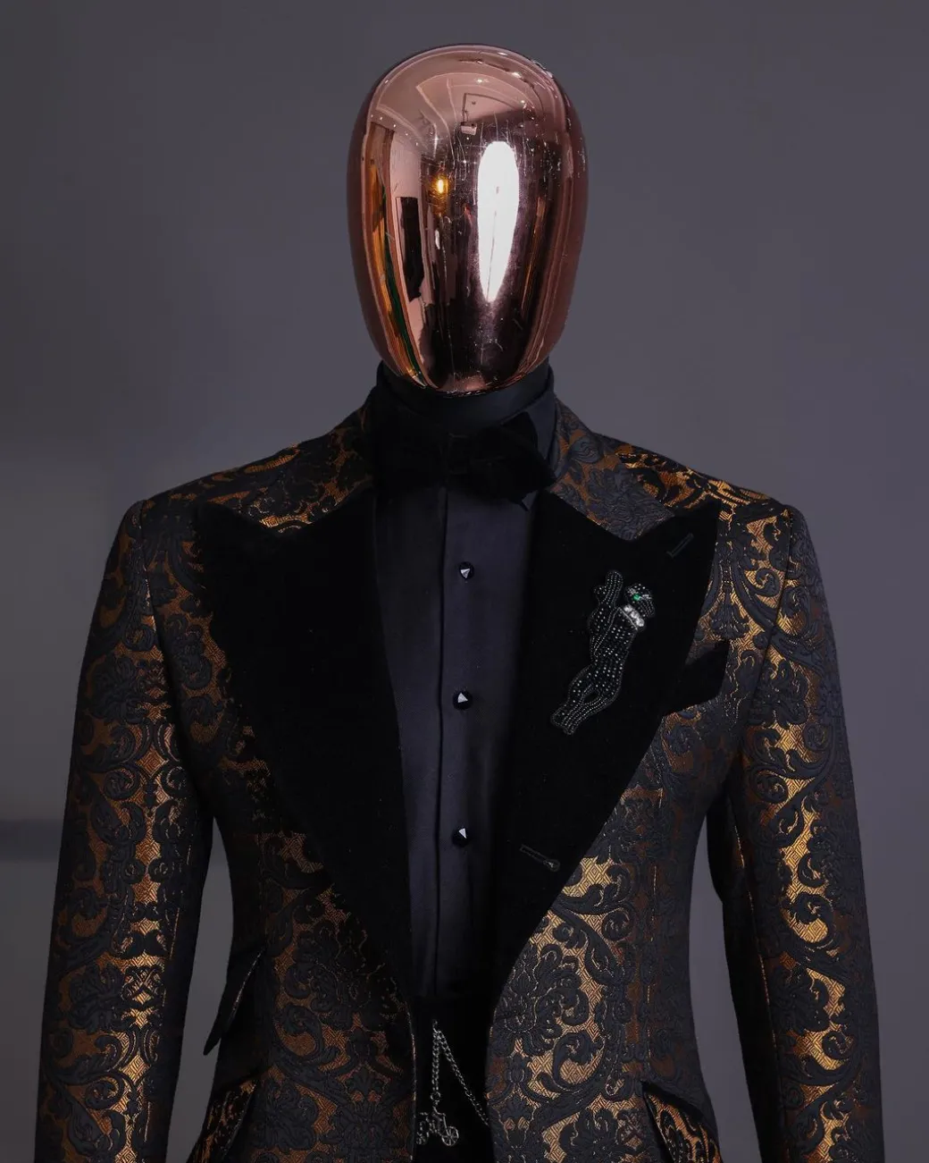 A Gold and black mandarin metallic floral jacquard, peak lapel tuxedo suit.