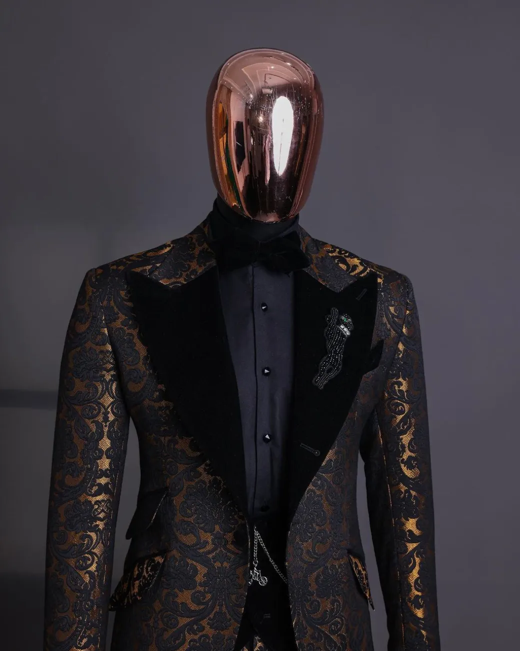 A Gold and black mandarin metallic floral jacquard, peak lapel tuxedo suit.