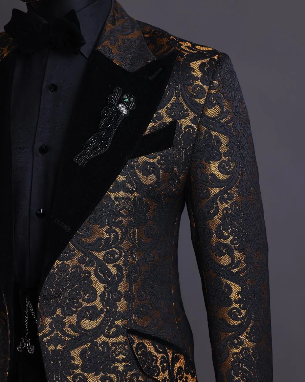 A Gold and black mandarin metallic floral jacquard, peak lapel tuxedo suit.