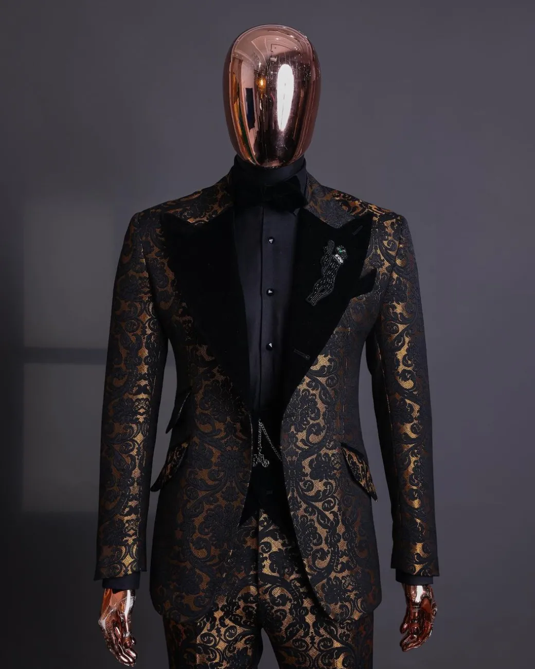 A Gold and black mandarin metallic floral jacquard, peak lapel tuxedo suit.
