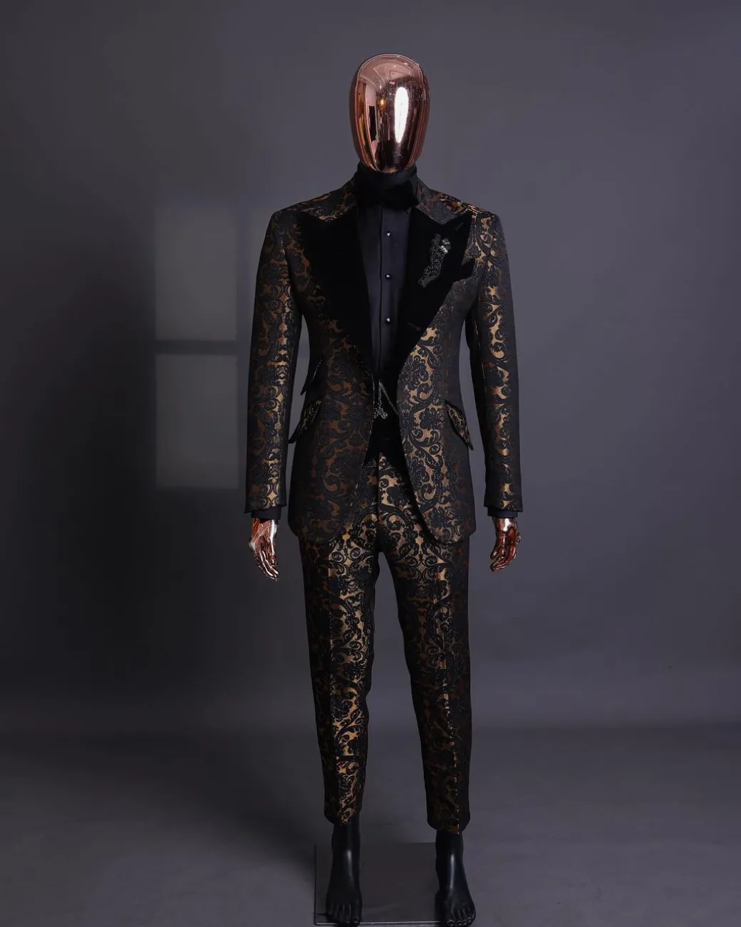 A Gold and black mandarin metallic floral jacquard, peak lapel tuxedo suit.