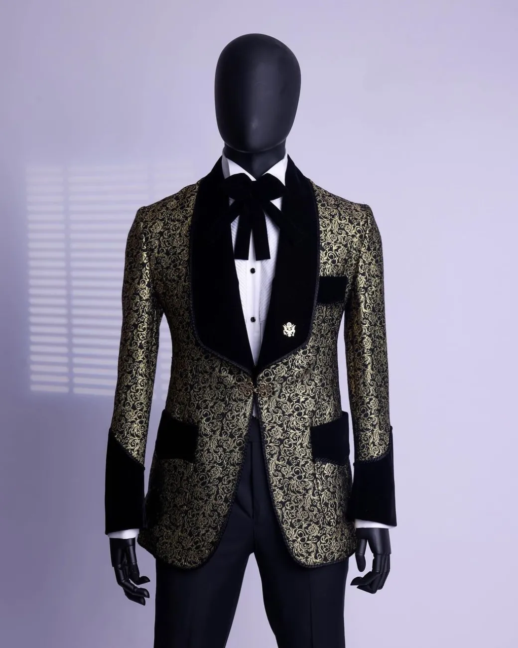 A Gold and black patterned metallic Jacquard tuxedo suit with sharaba wooven edge detailing