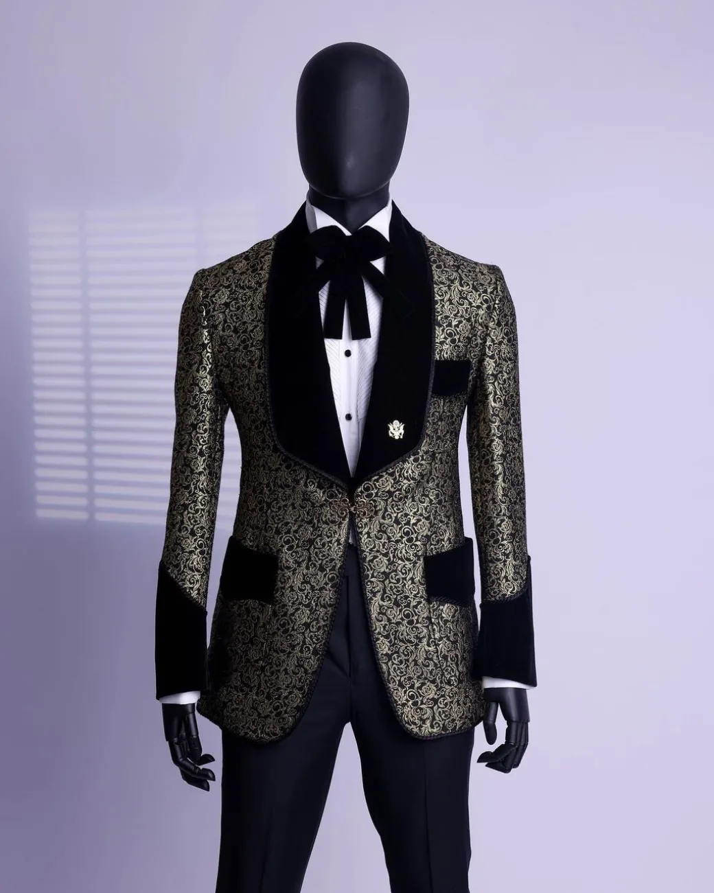 A Gold and black patterned metallic Jacquard tuxedo suit with sharaba wooven edge detailing