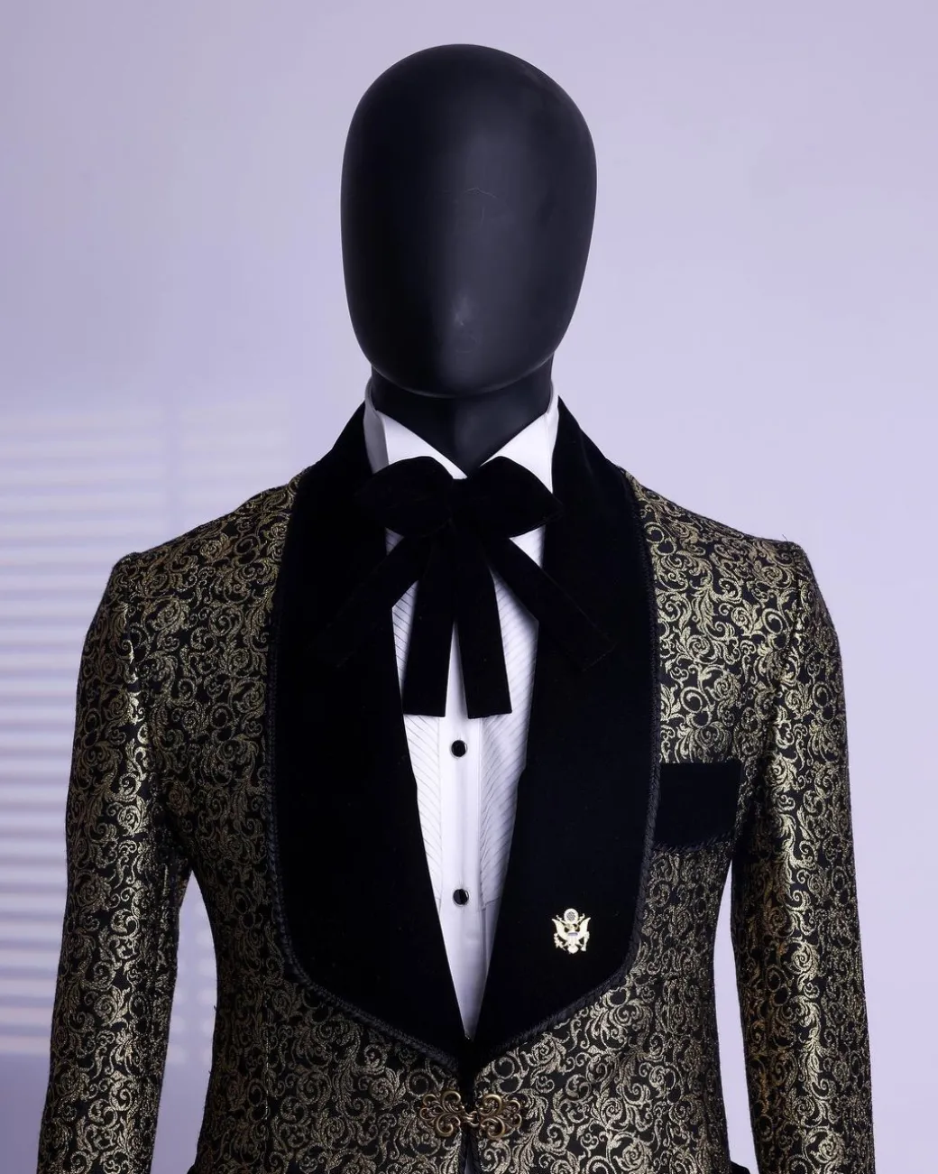 A Gold and black patterned metallic Jacquard tuxedo suit with sharaba wooven edge detailing