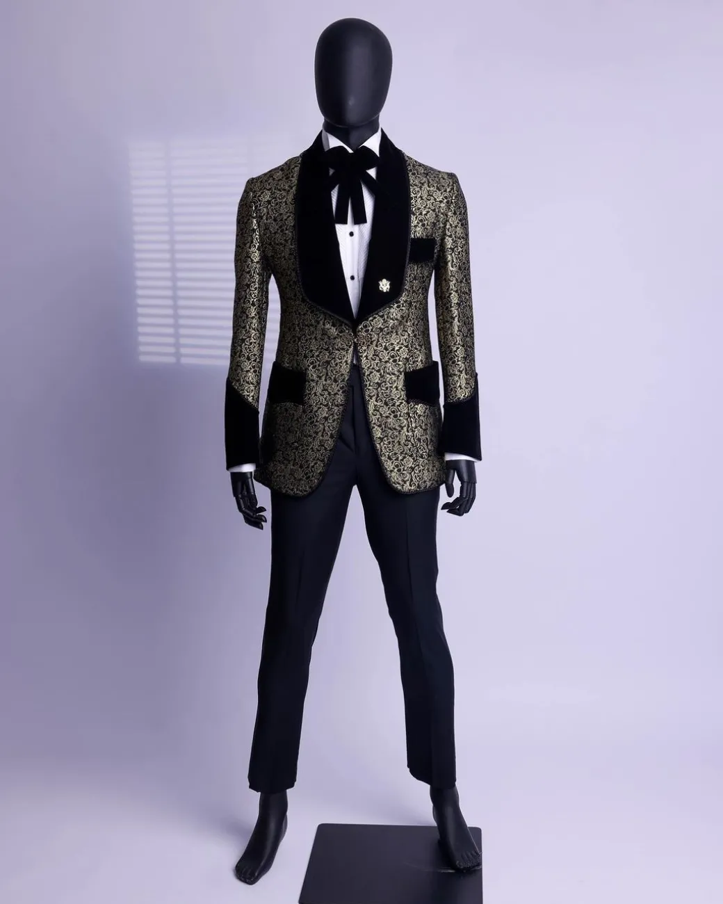 A Gold and black patterned metallic Jacquard tuxedo suit with sharaba wooven edge detailing
