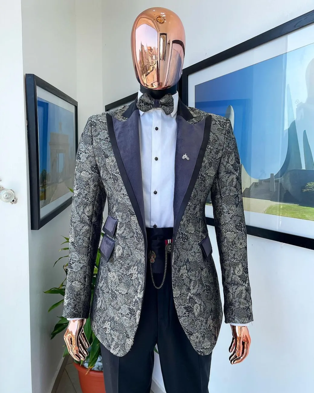 A grey floral jacquard peak lapel with black silk taping tuxedo suit