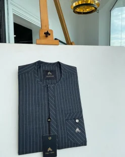 A grey pinstripe kaftan, front Flap with an inverse combat pocket Swarovski button details African traditional senator kaftan native.