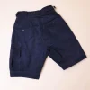 A “Gurkha”pant shorts with pleats, double side strap buckle, combat patch pocket.