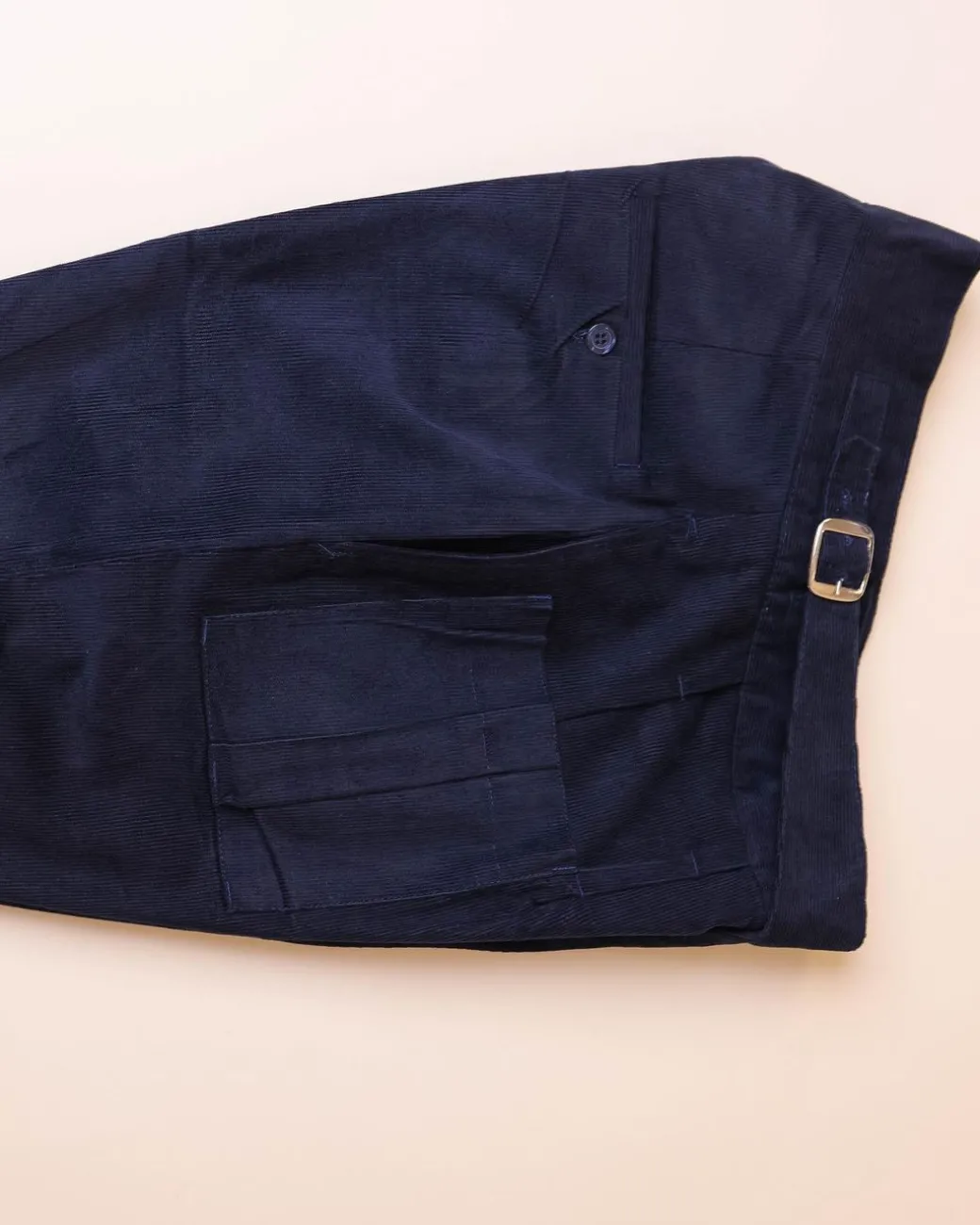 A “Gurkha”pant shorts with pleats, double side strap buckle, combat patch pocket.